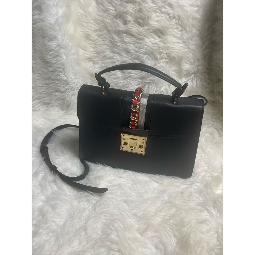 Steve MaddenโBlack Synthetic Top-Handle/shoulder bag Gold Lock Red Chain Accent